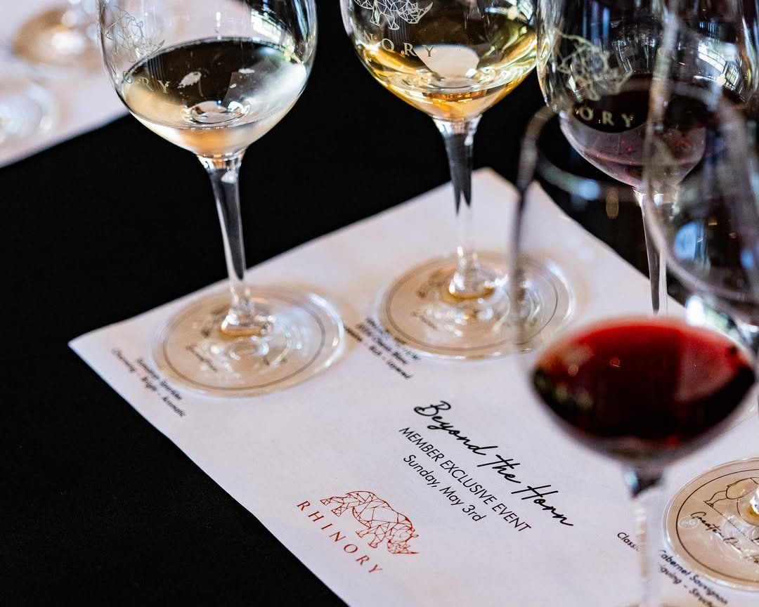 A tasting flight laid out on a printed Rhinory menu