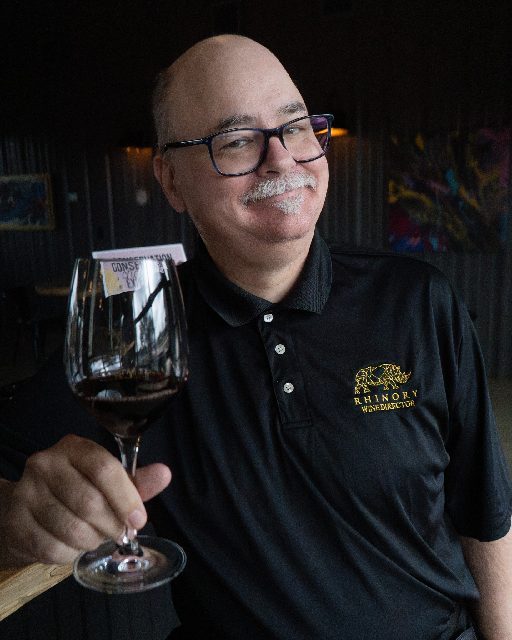 David Bradbury, Director of Wine, holding a glass of red in the tasting room